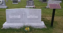 Large rectangular grey granite stone inscribed with names, birth years, and death years, of St. Laurent and his wife