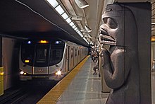 A Toronto Rocket subway train arrives at Museum station. The station is one of 70 operated along three different subway lines. Museum TTC 20806772132.jpg