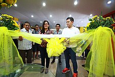 Iriga City Mayor Ronald Felix Alfelor and Maffeth Opiana cutting the ribbon to formally open the exhibit
