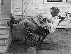 A Farmer Reading His Paper. Photographed by Ge...