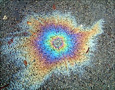 Oil on water creates an interference pattern in the colors of the spectrum