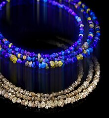 Necklace of rough light brown diamonds under UV light (top) and normal light (bottom) Rough diamonds - necklace in UV and normal light B - composite.jpg