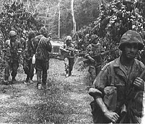 Portuguese Army special cacadores advancing in the African jungle in the early 1960s, during the Angolan War of Independence. Sempreatentos...aoperigo!.jpg