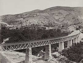 View of a nearby railway bridge showing the village in 1894