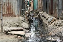 Lack of proper storm drains and sewer systems in Kalibari community in Mymensingh, Bangladesh - a common situation in urban slums in developing countries Drain in Kalibari community (3682826791).jpg
