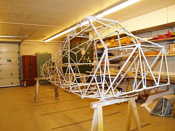 A stripped down tube and fabric construction fuselage from a Piper PA-18 Super Cub