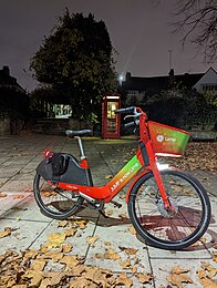 A bright red and green bike in the dark