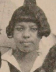 A young Black woman with hair cut into a bob with bangs