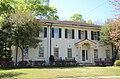 White two-story, red-brown roof