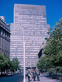 View of buildings on Bowling Green from a nearby sidewalk, looking toward 2 Broadway in the background