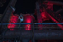 The still preserved but now dormant steel stacks of Bethlehem Steel at the company's former Bethlehem, Pennsylvania manufacturing headquarters. In 2007, much of the former headquarters was acquired by Sands Bethworks, a casino later sold and renamed Wind Creek Bethlehem. Steel Stacks Night.jpg
