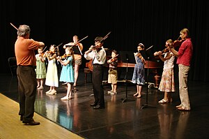 A primary focus of music psychology research concerns how best to teach music and the effects this has on childhood development. Suzuki violin recital.jpg