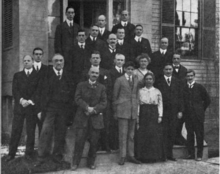 Двадцать ученых, в основном мужчины, стоят на групповой фотографии 1916 года.