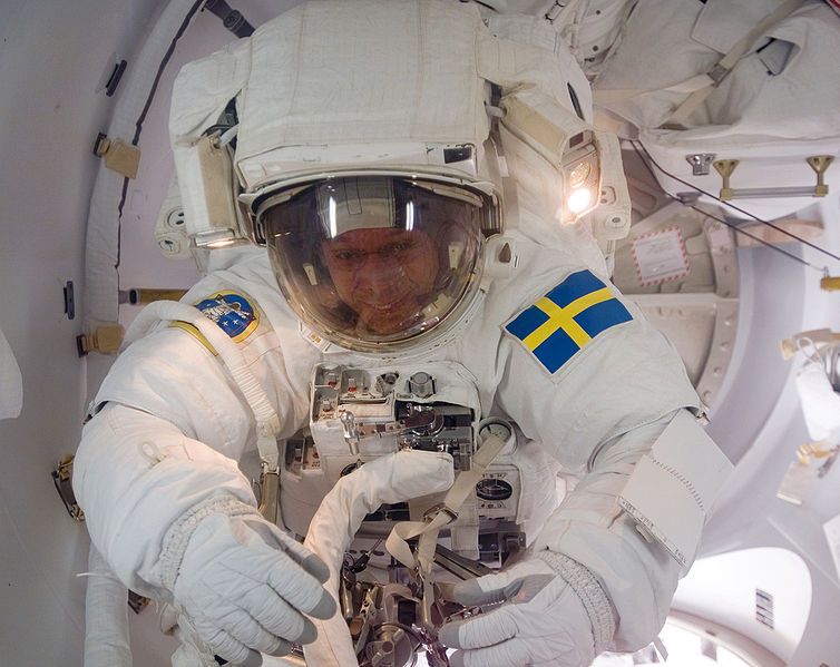 As the mission's first spacewalk draws to a close, European Space Agency (ESA) astronaut Christer Fuglesang, STS-116 mission specialist, moves through the Quest Airlock as he returns to the International Space Station. 