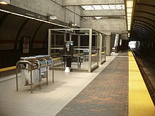 A designated waiting area (DWA) at Glencairn station. DWAs are well-lit waiting areas that are monitored, have intercoms, and are situated near the location where the guard car stops. Glencairn TTC DWA.JPG