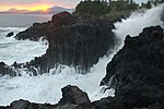 Jungmun Daepo Columnar Joints with waves crashing.jpg