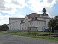 Fabrik mit großen Hauptbau mit zwei hinteren Anbauten und Rampe zum Ausziehgleis (Nr. 11) sowie dem straßenbegleitenden flachen Bau (Nr. 13)