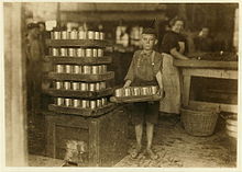 Child labor at J.S. Farrand Packing Company in Baltimore, 1909. Photo by Lewis Hine. One of the small boys in J. S. Farrand Packing Co. and a heavy load.jpg