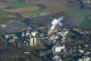 A table sugar factory in England. The tall diffusers are visible to the middle left where the harvest transforms into a sugar syrup. The boiler and furnace are in the center, where table sugar crystals form. An expressway for transport is visible in the lower left. Sugar Beet Factory, England.jpg