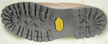 Detail of the original Vibram "Carrarmato" lug shoe sole design with the yellow Vibram emblem Vibram Carrarmato sole.png