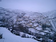 Villar del Cobo village under the Montes Universales during a winter snowstorm