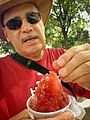 Man eating a piragua (Puerto Rican shaved ice) in Paseo de la Princesa in 2014