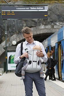 A young father with a baby in Stockholm, Sweden (2015). Dad with a Bjorn.jpg