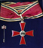 Badge suspended on neck riband of the class "Commander's Cross"