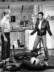 Richie and Fonzie view his destroyed motorcycle in his living room, 1976. Fonzie's apartment was over the Cunninghams' garage. Happy days 1976 fonzies apartment.JPG