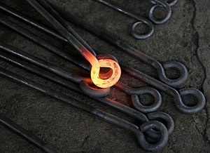 Hot metalwork from a blacksmith. The yellow-or...