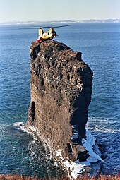 CH-113 Labrador landing on "The Clapper", a sea stack off the tip of Bell Island in Newfoundland Labrador helicopter landing Bell Island.jpg