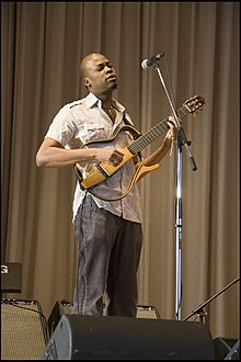 Loueke playing a skeleton guitar. Photo by Sheldon Levy