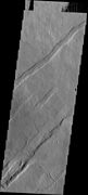 Oti Fossae, as seen by THEMIS. These parallel graben are found on the northeastern side of Arsia Mons; they are in line with the NE/SW trend of the three volcanoes in Tharsis.