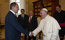 Francis shaking hands with Russian Foreign Minister Sergey Lavrov, in front of Russian President Vladimir Putin, 10 June 2015 Vladimir Putin with Franciscus (2015-06-10) 1.jpg