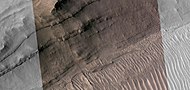 Close view of layers, as seen by HiRISE under HiWish program Part of picture is in color. A ridge cuts across the layers at a right angle.