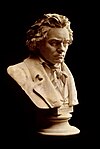 A small marble bust of Beethoven by Hugo Hagen, with a black background