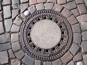 German standard manhole cover with infills of ...