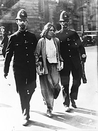 A suffragette arrested in the street by two police officers in London in 1914 Suffragette arrest, London, 1914.jpg