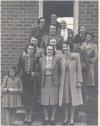 Some of Tallangatta VAOC members pose at the steps of the observation post - circa 1944. Front row from left: Olga Smith, Mrs A. Smith, Maise Tait, Thelma Butler. Second Row - Mrs Ballantyne, Helen Tait, Mrs J. L. Fisher. Third row: Madge Maddock, Mrs H. G. Heath and daughter behind. Fourth row: Miss Myrtle Ruby, unknown, Mrs Pearl Foster. Photo: Thelma Moyle.