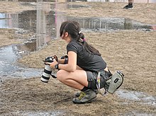 A woman press photographer covers a music festival, Poland, 2008 Woodstock press photographer.jpg