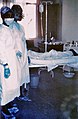 Two nurses standing near Mayinga N'Seka, a nurse with Ebola virus disease in the Mabalo Lokela 1976 outbreak in Zaire]]. N'Seka died a few days later.