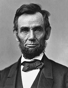 A bearded Abraham Lincoln showing his head and shoulders.