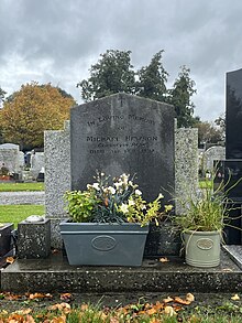 Gravestone of Michael Hewson (Irish Librarian) with two flower pots in front of it. Inscription reads "In loving memory of Michael Hewson, Glasnevin Park, died 3rd Feb 1992".