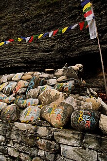 Mani stones in Nepal showing symbolic colouring of each syllable Prayer stones Nepal.jpg