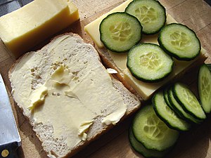 Making cheese and cucumber sandwiches