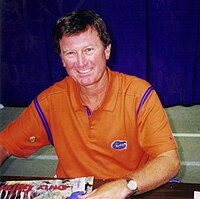 Steve Spurrier, smiling in an orange Gators shirt