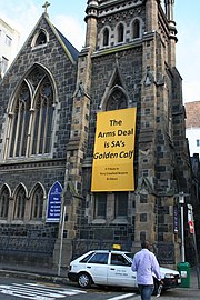 A yellow banner on the church criticizing the South African Arms Deal.