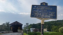 a picture of the historical marker, with the bridge behind it