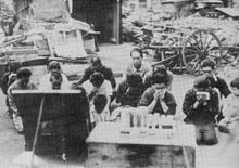 Civilians listening to the emperor's surrender broadcast, on August 15, 1945 Japanese civilians listening to the surrender broadcast.jpg