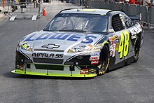 The front side view of a grey and black race car